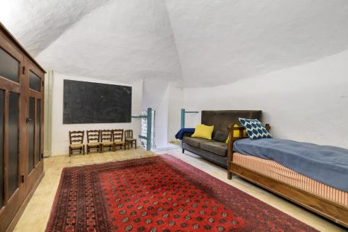 a bedroom with a bed and a couch at Chateau- La Providence in Satillieu