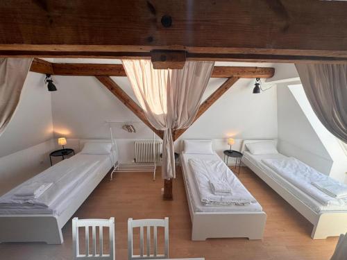 a room with two beds and two chairs at Bavaria Home Kitchen Parks No 5 in Geisenfeld