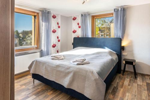 a bedroom with a bed with two towels on it at Haus Schmucker in Hohekreuz