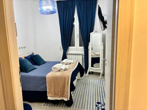 a bedroom with a bed with towels on it at Astrea Apartament in Tropea