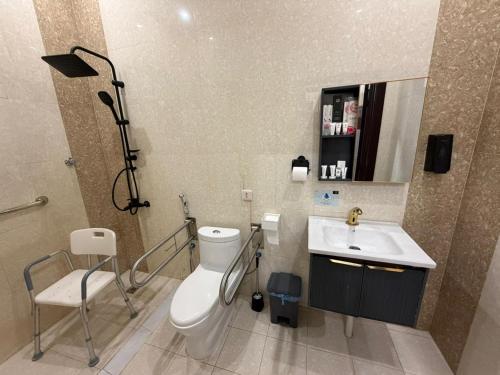 a bathroom with a toilet and a sink at الجوهرة بارك للشقق المخدومة 7 in Riyadh
