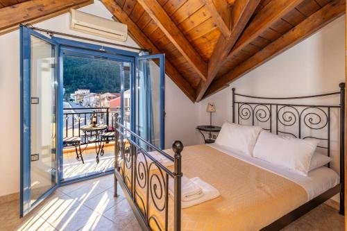 a bedroom with a bed and a balcony at VERANDA MARE in Agia Effimia