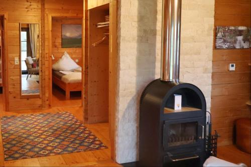 a wood stove in a room with a bedroom at Ferienhaus Tauber 21 in Hayingen