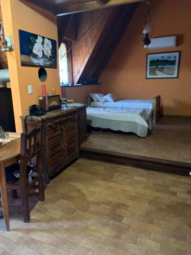 a bedroom with two beds and a desk and a table at cabañas los juanes in Tres Arroyos