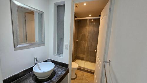 a bathroom with a sink and a toilet at Comfortable apartment with pool, close to the beach in Acapulco