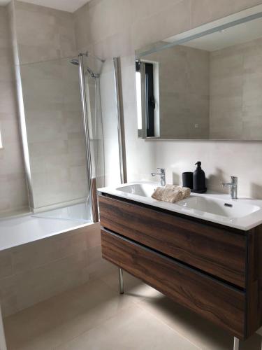 a bathroom with a sink and a bath tub at Casa Dulcelina Monte Gordo, Algarve, Portugal in Monte Gordo