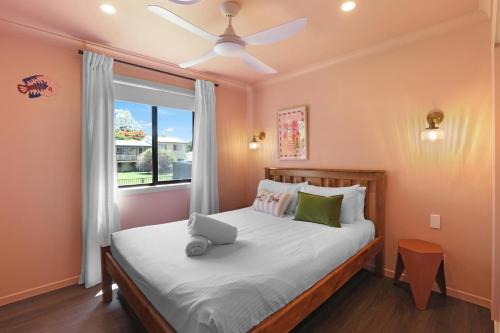 a bedroom with a bed with a laptop on it at Amity Duo - Roys in Amity Point