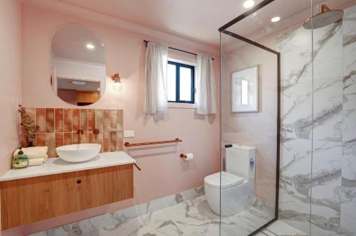 a bathroom with a toilet and a sink and a shower at Amity Duo - Roys in Amity Point