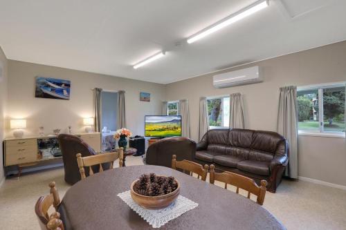 a living room with a table and a couch at Betty's Place in Amity Point