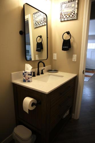 a bathroom with a sink and a mirror and a toilet at Retreat on First Street in Prescott