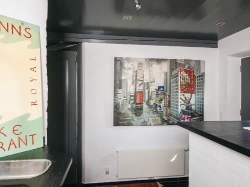a kitchen with a painting of a city at Home with Spa and Fireplace in Fanø