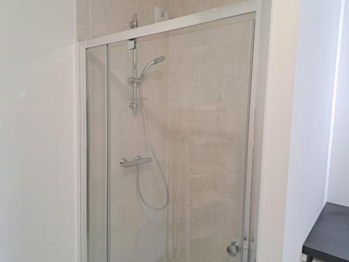 a shower with a glass door in a bathroom at Sea View Family Stay in Plouarzel in Plouarzel