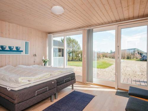 a bedroom with a bed and a large window at 8 person holiday home in Tarm in Tarm