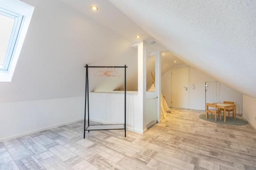 a basketball hoop in a white room with a table at Cottage am Deich Whg Mareile in Uelvesbüll