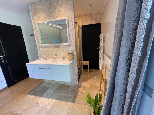a bathroom with a white sink and a mirror at 15 min from Lyon Fresh Peaceful Room with Pool and Garden in Dardilly