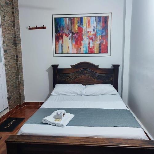 a bedroom with a bed with a towel on it at Casa hotel salcon la floresta in Barrancabermeja