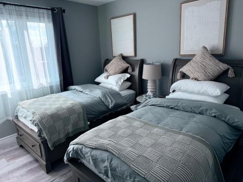 a bedroom with two beds and a window at Spacious New 3BR Townhome Walking to Falls in Niagara Falls