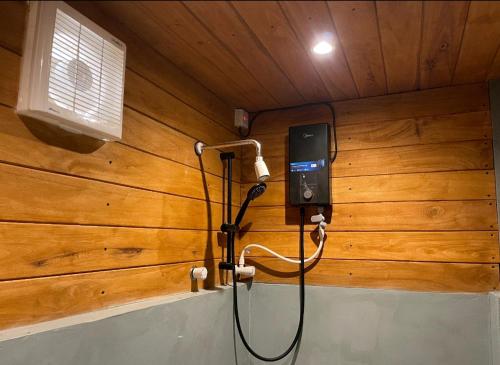 a room with a cell phone hanging on a wall at Cool Banyan Cabana in Trincomalee