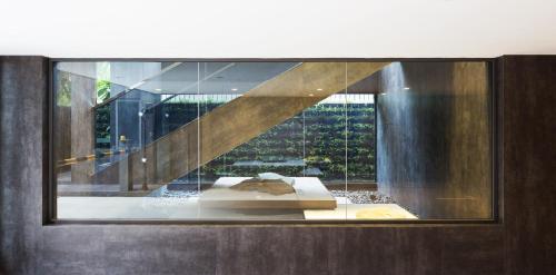 a glass display case with a sculpture in a building at One Residence Hotel & Apartment in Phnom Penh