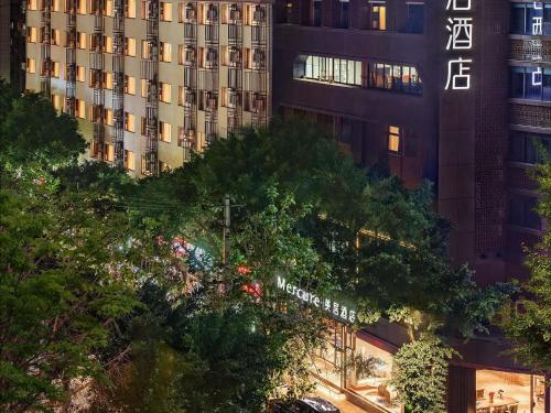 a tall building with a sign in front of it at Mercure Chengdu Wuhou Temple in Chengdu