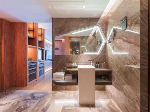 a bathroom with a sink and a mirror at Mercure Beijing Dongzhimen in Beijing