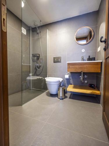 a bathroom with a toilet and a sink and a shower at Casa Alegre Alaçatı in Alaçatı