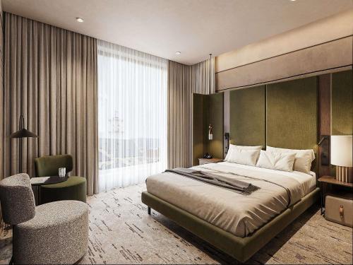 a bedroom with a bed and a desk and a chair at Novotel Lviv Center in Lviv