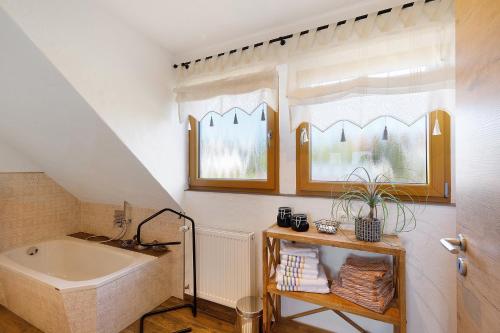 a bathroom with a tub and a sink at Fewo Sonnenstübchen Mendig 2Pers in Mendig