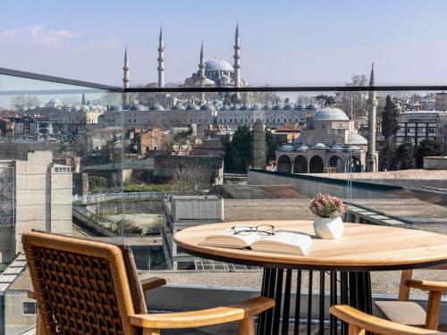 a table and chairs with a view of a city at Mövenpick Istanbul Old Town in Istanbul