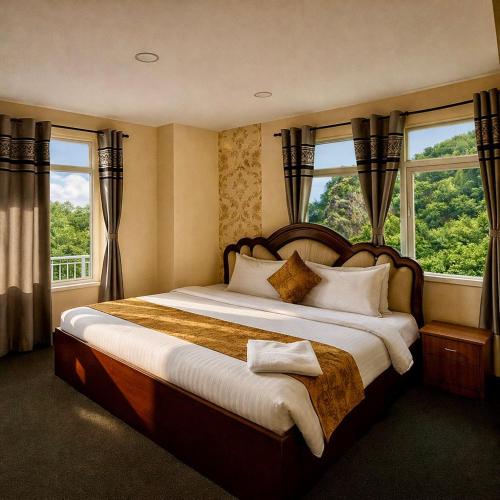 a bedroom with a large bed in front of windows at Heritage Rose Inn in Srinagar