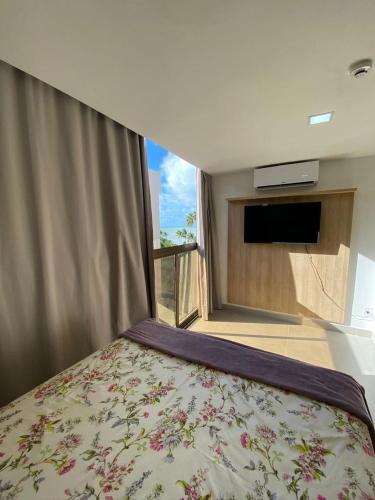 a bedroom with a large bed with a window at Flat FM20 Apt 401 in João Pessoa