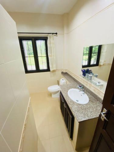 a bathroom with a sink and a toilet at Tha sala beach house in Ban Phang Pling