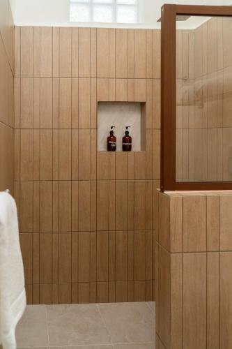 a bathroom with two bottles of honey on a wall at Saules Armonía in Cancún