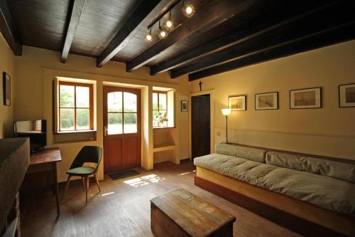 a living room with a couch and a table at Pierre-brune in Saint-Priest-Taurion