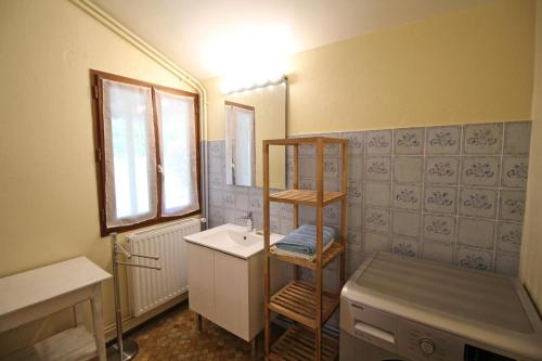 a bathroom with a sink and a towel shelf at Pierre-brune in Saint-Priest-Taurion