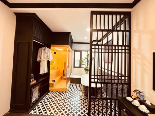 a bathroom with a black and white tile floor at Cera Hotel in Ho Chi Minh City