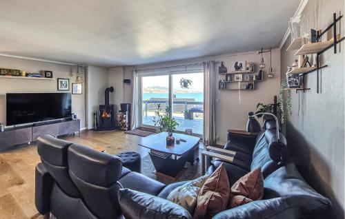 a living room with a couch and a large window at Nice Home In Ask With Wifi in Ask i Nordhordaland