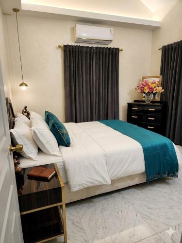 a bedroom with a bed and a dresser at Crown Point Condos by Nasin in Crown Point