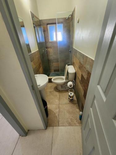 a bathroom with a toilet and a sink and a shower at Crown Point Condos by Nasin in Crown Point