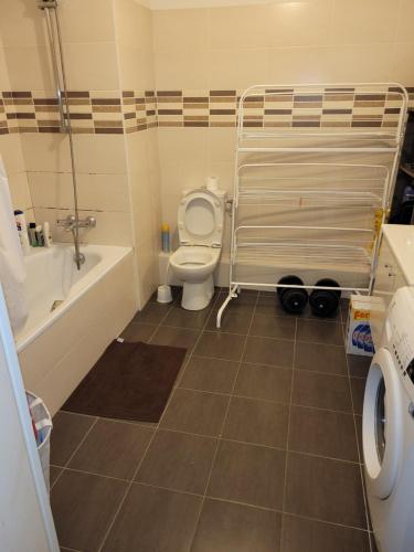 a bathroom with a toilet and a tub and a sink at Repos chez l habitant in Rennes