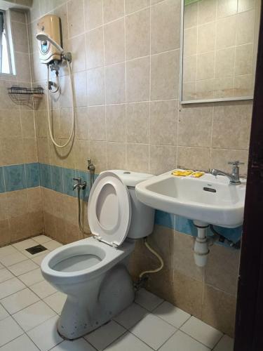 a bathroom with a toilet and a sink at Hotel Wings Kuala Lumpur in Kuala Lumpur