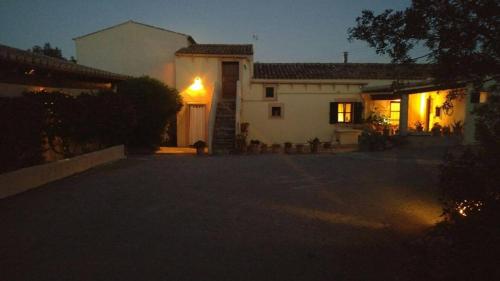 a large white house at night with a driveway at Agroturisme s' Horta in Capdepera