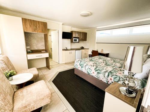 a hotel room with a bed and a couch at Dalby Parkview Motel in Dalby