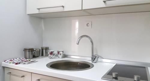 a kitchen with a sink and a counter top at Colors Apartment in Skopje