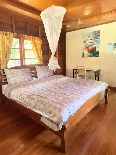 a bedroom with a large bed in a room at Namtok Bungalows in Ko Yao Noi