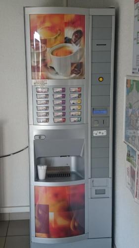 a refrigerator with food inside of it at Première Classe Clermont Ferrand Nord in Clermont-Ferrand
