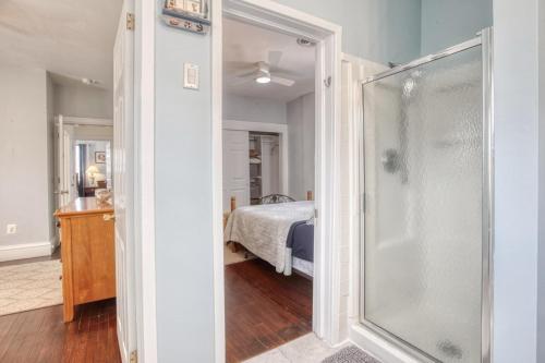 a bathroom with a shower and a bedroom with a bed at Sunshine House in Ventnor City