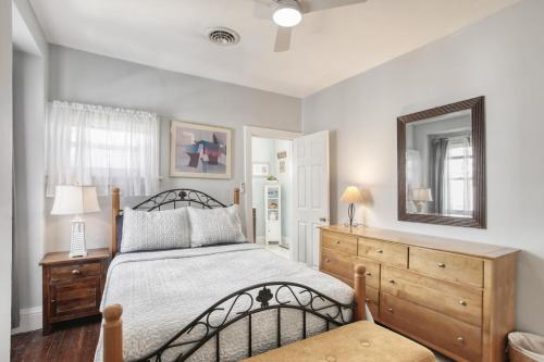 a bedroom with a bed and a mirror and a dresser at Sunshine House in Ventnor City