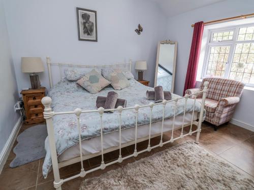 a bedroom with a white bed and a mirror at Riverlea in Rhyl