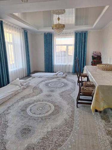 a large room with a bed and a table at Miyar Farmhouse in Ak-Say